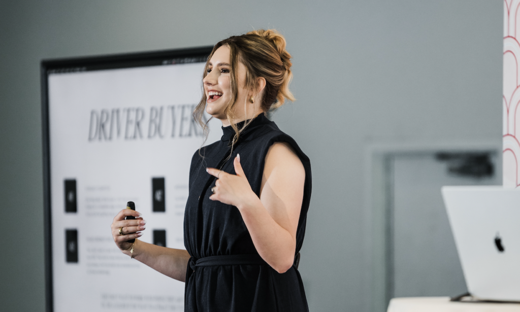 female speaker talking at an event about creating content